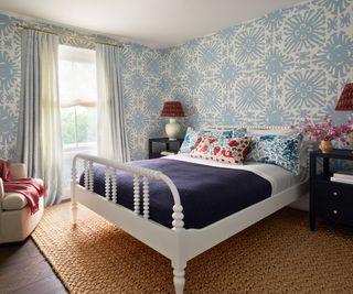 bedroom with bobbin bed and blue wallpaper