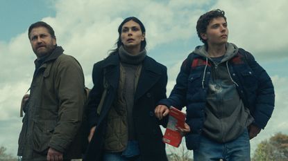 Gerard Butler as John Garrity, Morena Baccarin as Allison Garrity, and Roman Griffin Davis as Nathan Garrity in Greenland 2: Migration.