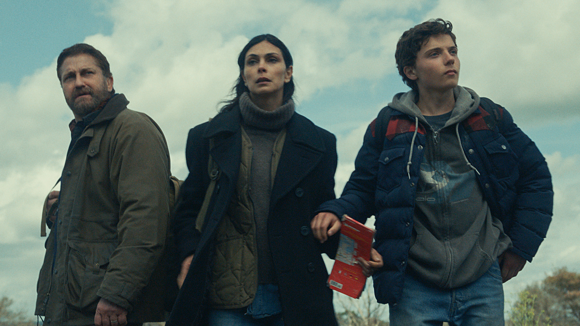 Gerard Butler as John Garrity, Morena Baccarin as Allison Garrity, and Roman Griffin Davis as Nathan Garrity in Greenland 2: Migration.