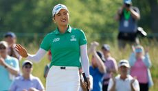 Minjee Lee waves to the crowd on the 18th green