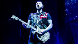 Zacky Vengeance on stage with a left-handed guitar