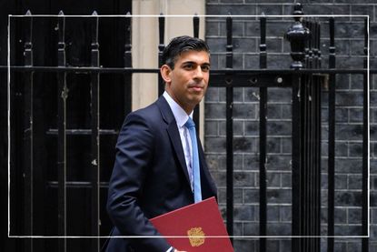 Former Chancellor Rishi Sunak who announced the £400 energy rebate pictured holding the red budget folder outside Downing Street