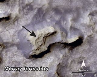 This mesa within the "Murray Buttes" area on Mars evinces a complex fracture pattern (black arrow) protruding from the eroding rock. Image taken with the High Resolution Imaging Science Experiment (HiRISE) camera. Image released Sept. 11, 2014.