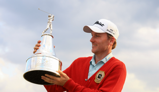 Russell Henley holds the Arnold Palmer Invitational trophy