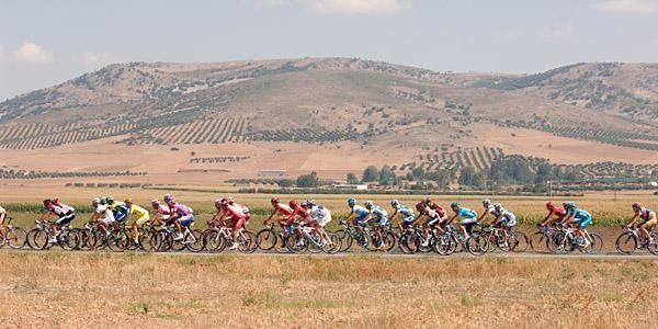 The peloton speeds past the desert-like landscape