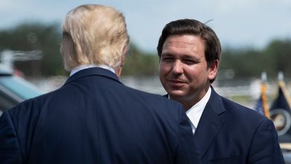 Donald Trump is greeted by Florida Governor Ron DeSantis