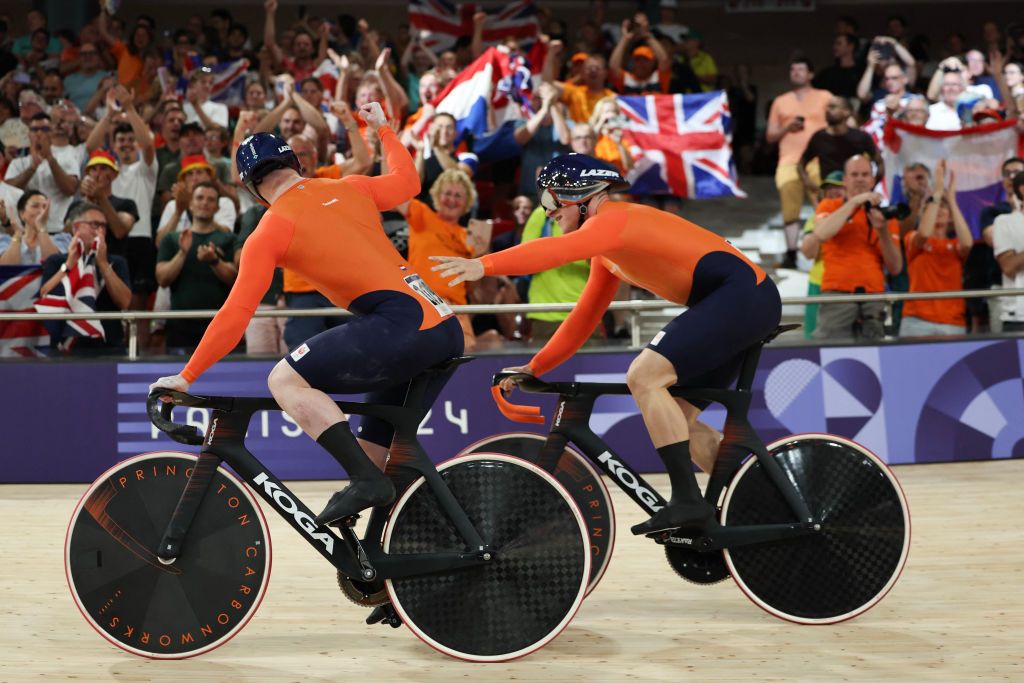 Netherlands' Roy van den Berg and Netherlands' Jeffrey Hoogland celebrate winning the men's track cycling team sprint final for gold of the Paris 2024 Olympic Games at the Saint-Quentin-en-Yvelines National Velodrome in Montigny-le-Bretonneux, south-west of Paris, on August 6, 2024. (Photo by Thomas SAMSON / AFP)
