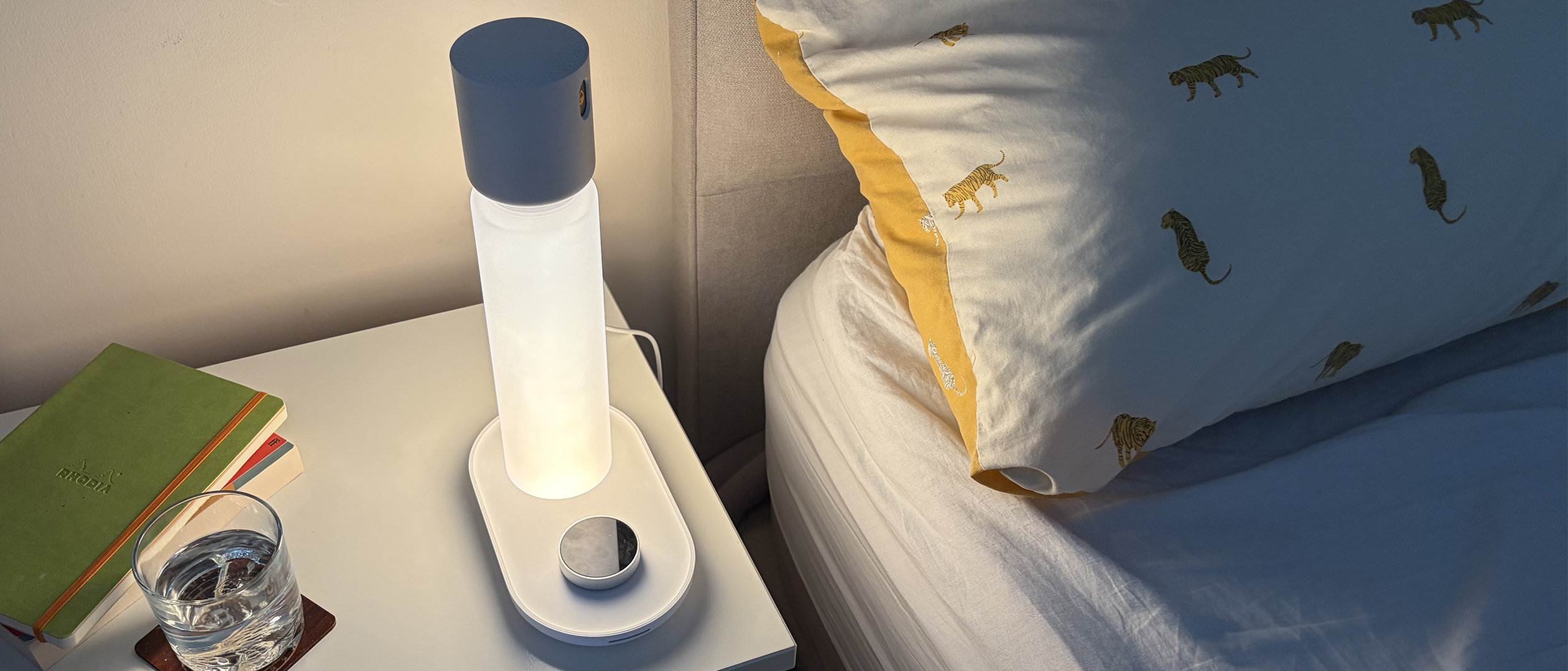The Sleepal AI Lamp on a nightstand in our reviewer's bedroom