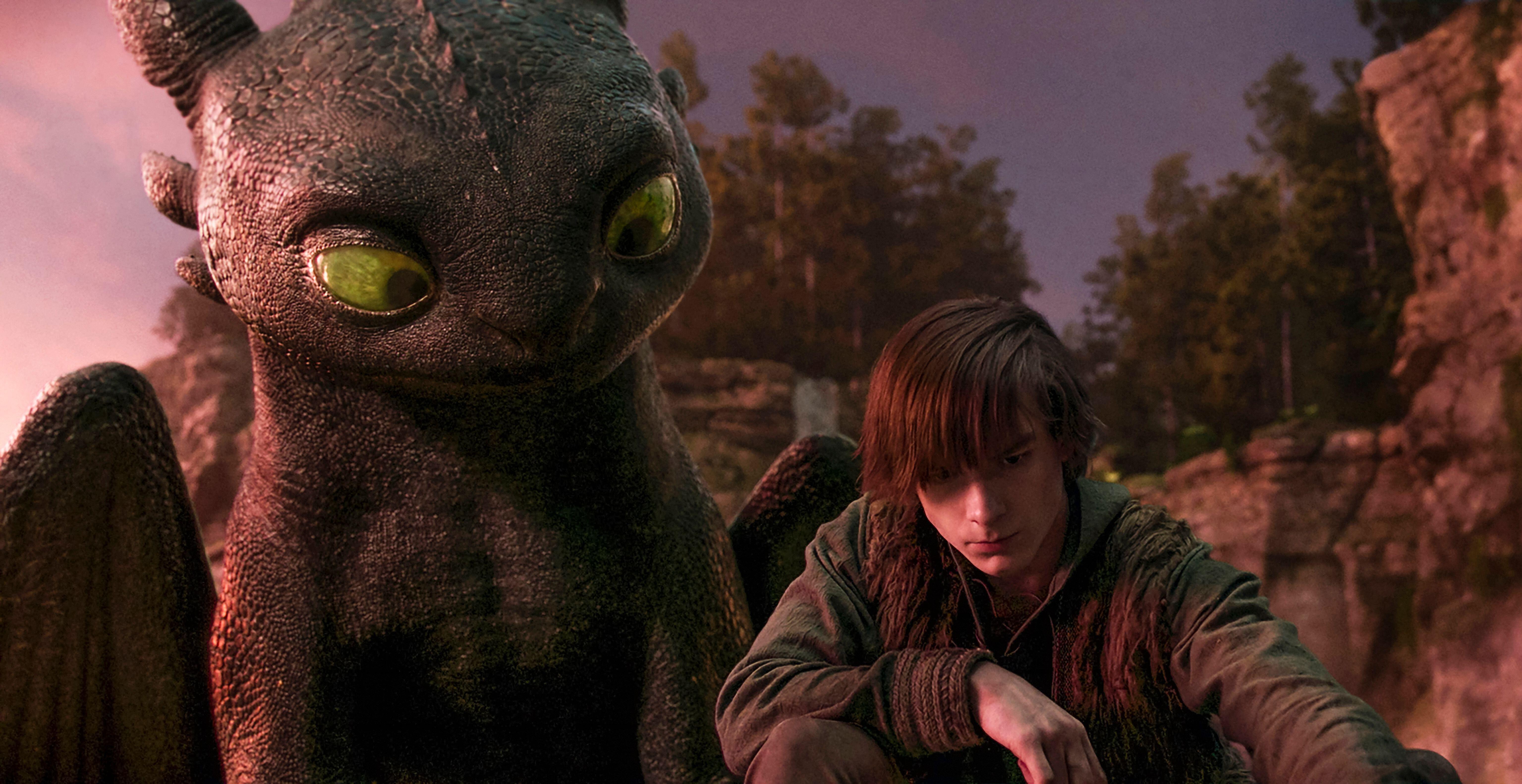 mason thames as hiccup beside CGI toothless in a cove in the 2025 how to train your dragon remake