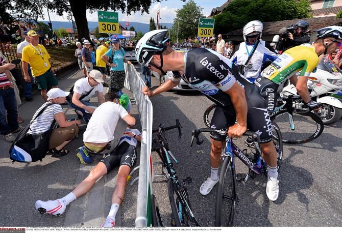 Tom Boonen checks on teammate Mark Cavendish, who crashed on stage 5