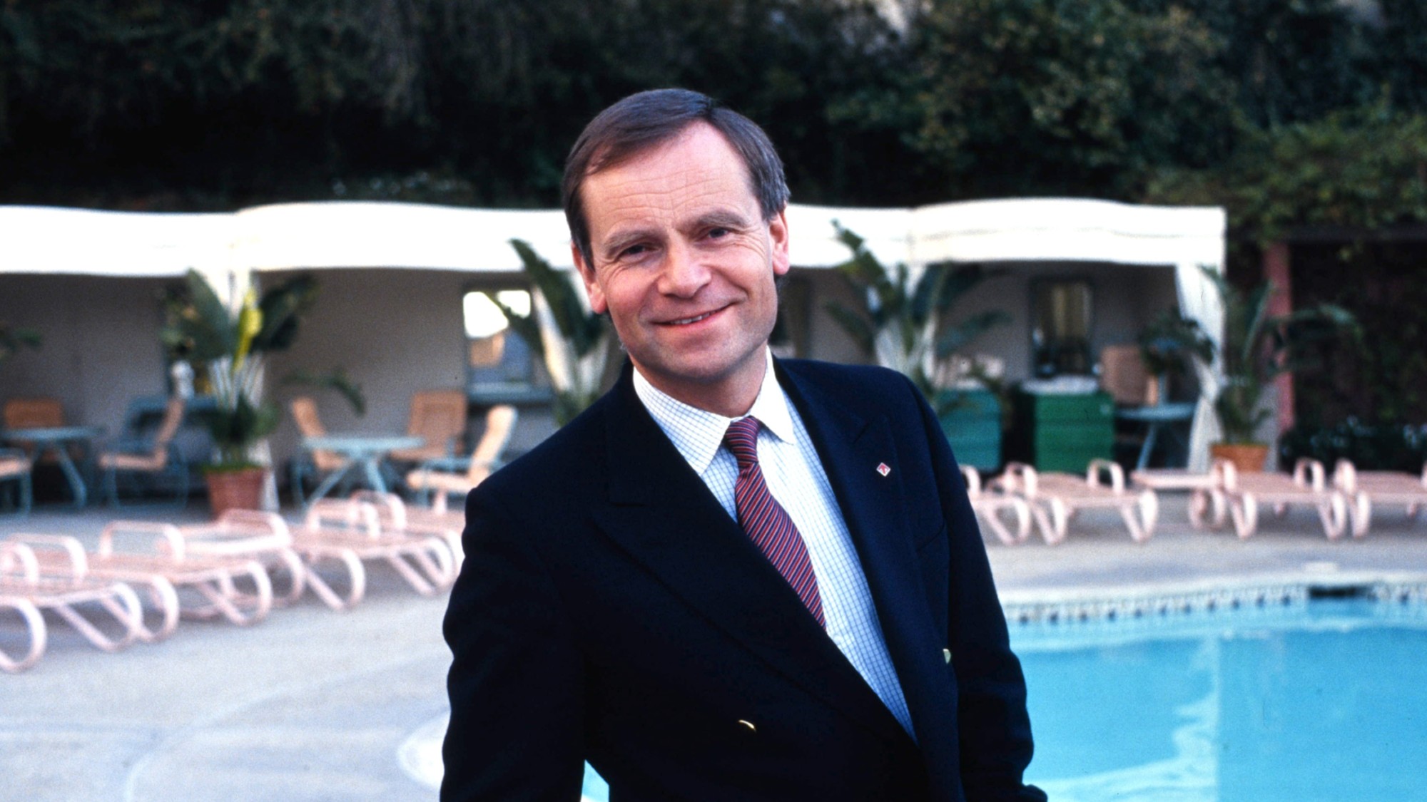 Jeffrey Archer in Beverly Hills with a swimming pool in the background