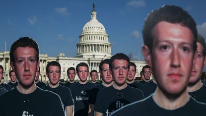 Protesters don Mark Zuckerberg mask before his Senate hearing