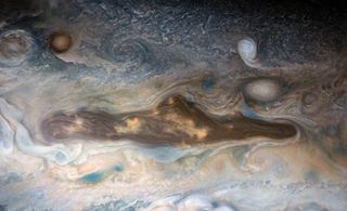 a funny face seen in the swirling gases of jupiter's atmosphere.