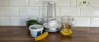 The Millo Smart Portable Blender surrounded by ingredients to make a fruit and vegetable smoothie