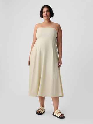a model wears an off-white strapless midi dress