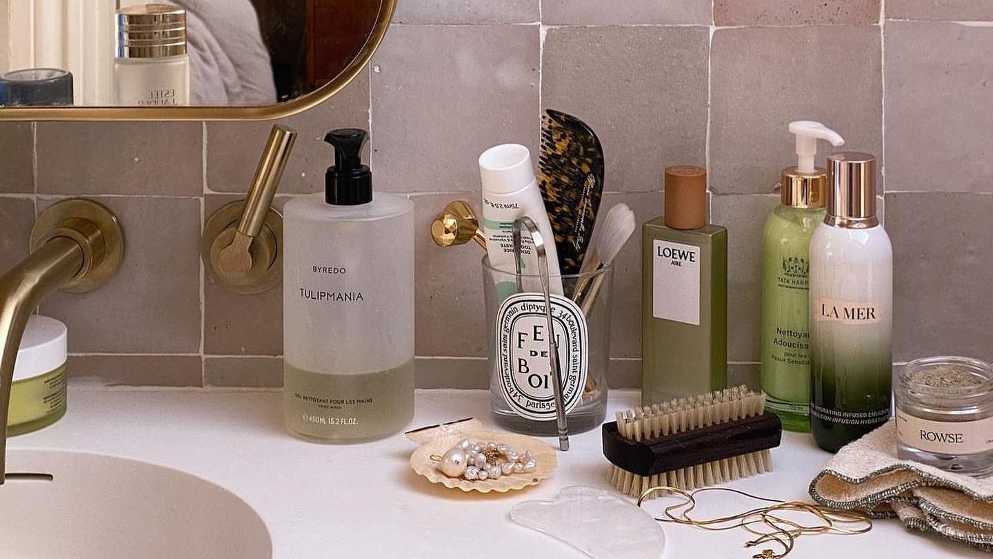 Photo of skincare products lined up on a bathroom sink