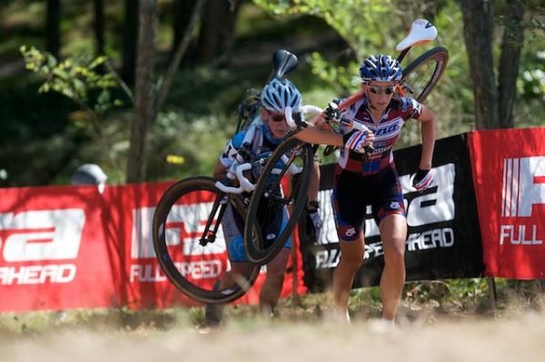 Helen Wyman (Kona) and eventual race winner Sue Butler (Monavie-Cannondale) shoulder their bikes on the run up.
