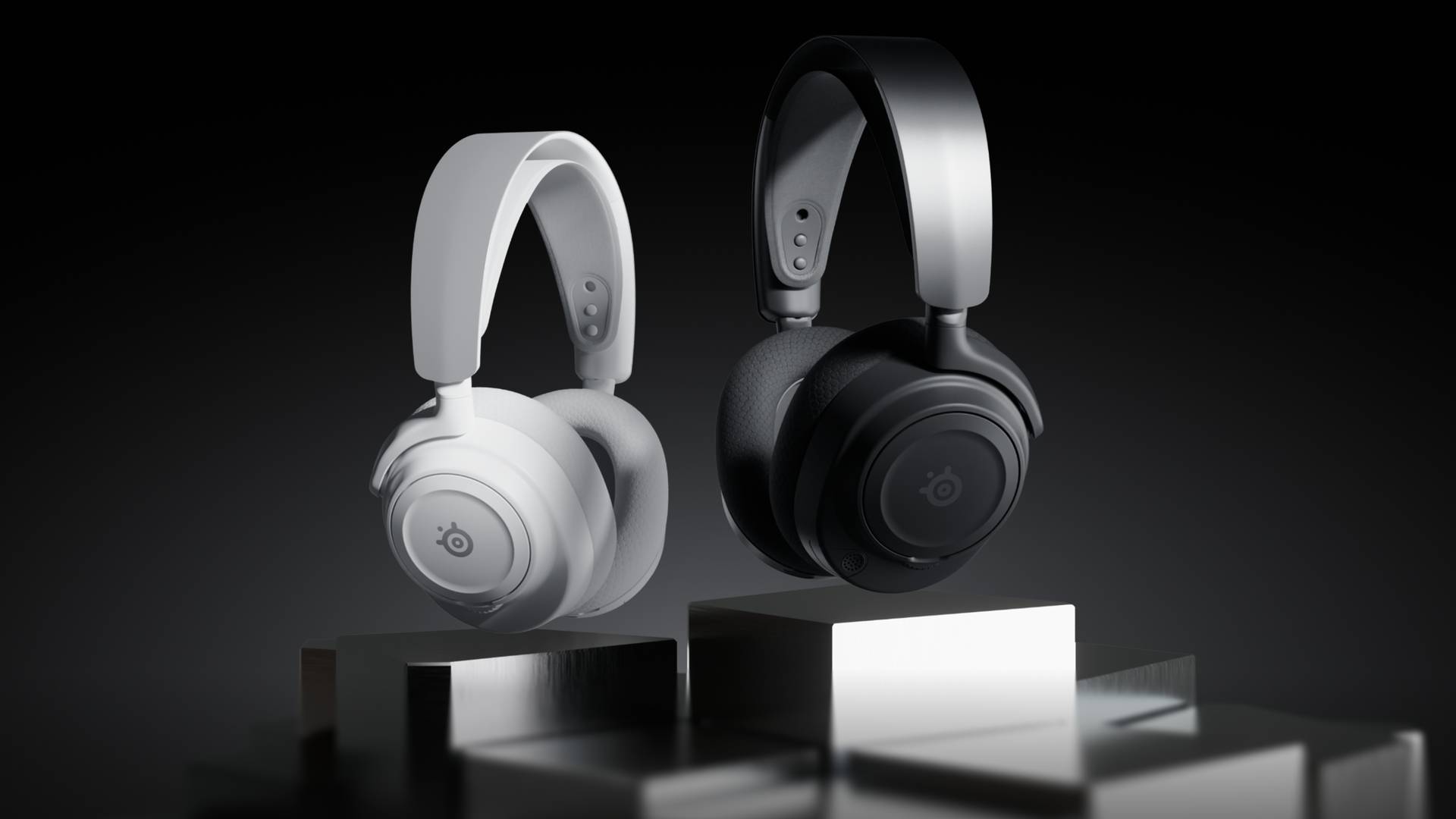 Image of a white and black headset hovering in the middle of the frame, with a black background.