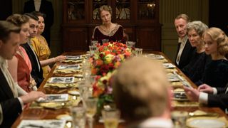 Gillian Anderson sits at the head of a table in The First Lady