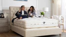 A couple sit on the brand new The Royal Bliss European Handcrafted Mattress