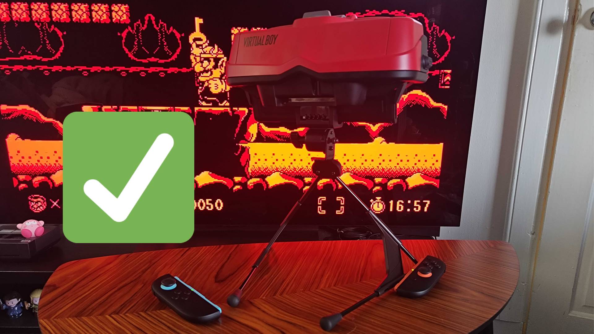 Virtual Boy with stand V-shape pointing forwards with green tick on left hand side.