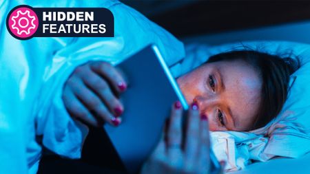 A young woman falling asleep in bed while watching her tablet
