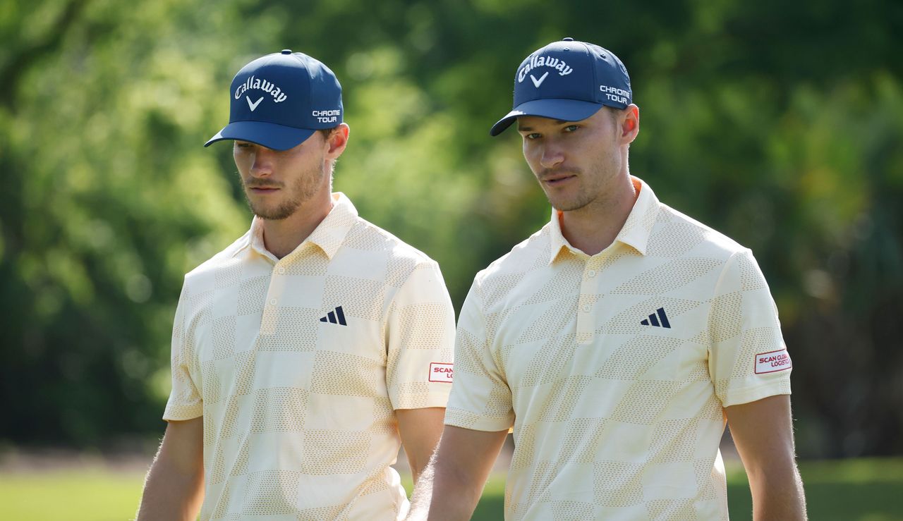 Nicolai and Rasmus Hojgaard walk on the fairway