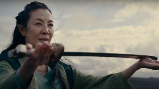 Michelle Yeoh as Scian holding an elven sword in The Witcher: Blood Origin