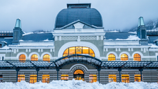 The façade of Canfranc Estación in winter with snow piled outside