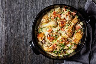 chicken thighs and drumsticks in white wine cream sauce with mustard and spices, White Wine Coq au Vin, chicken stew, horizontal view from above, flat lay, free space (chicken thighs and drumsticks in white wine cream sauce with mustard and spices, Wh