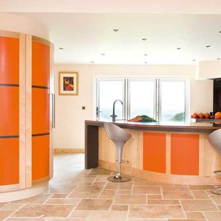 kitchen with orange coloured cabinets and tap