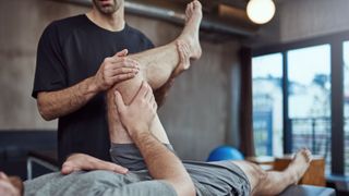 Person suffering with muscle tightness having physical therapy