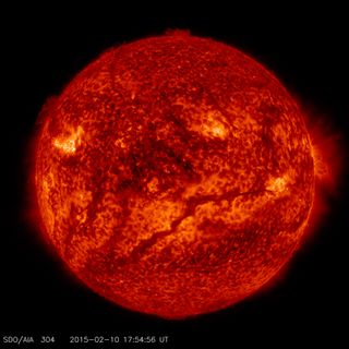 A dark, snaking line across the lower half of the sun in this image, captured by NASA's Solar Dynamics Observatory on Feb. 10, 2015, shows a filament of solar material hovering above the sun's surface.
