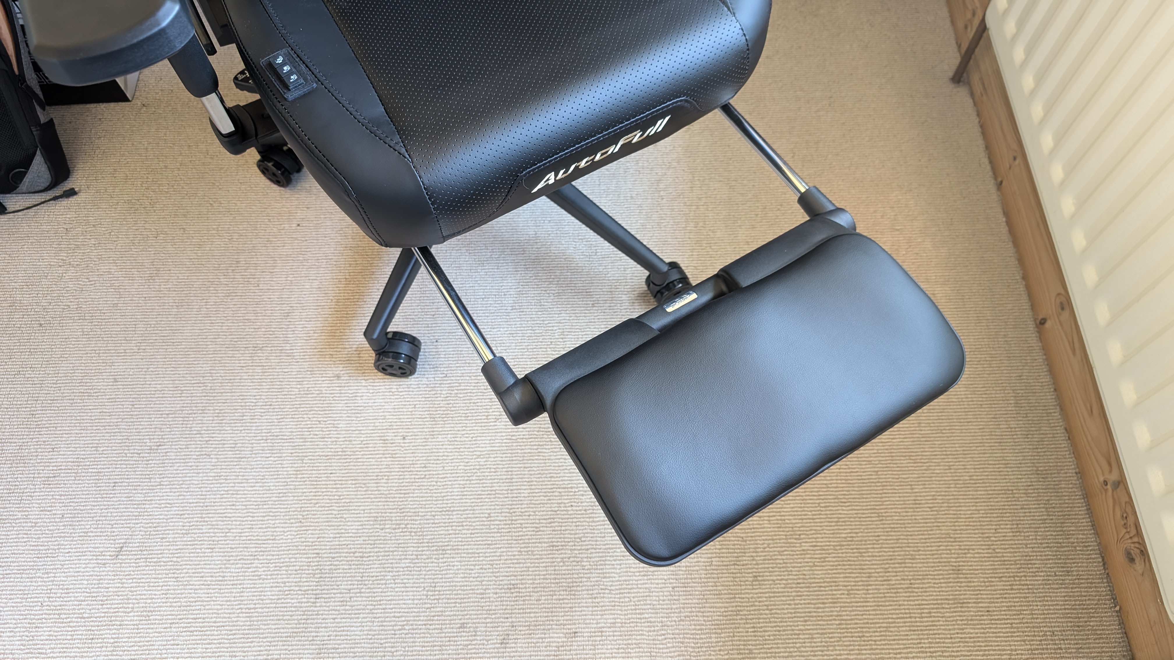 The AutoFull M6 Ultra gaming chair pictured in front of a desk with a gaming PC setup.