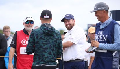 Lowry laughs on the tee with Justin Thomas and caddies