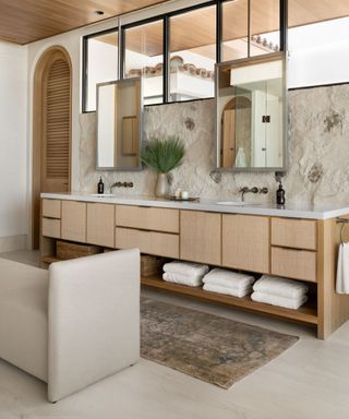 Bathroom with large double vanity with wood front, runner and bench seat