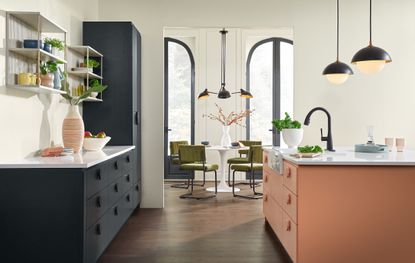 A kitchen with blue cabinetry and a terracotta island