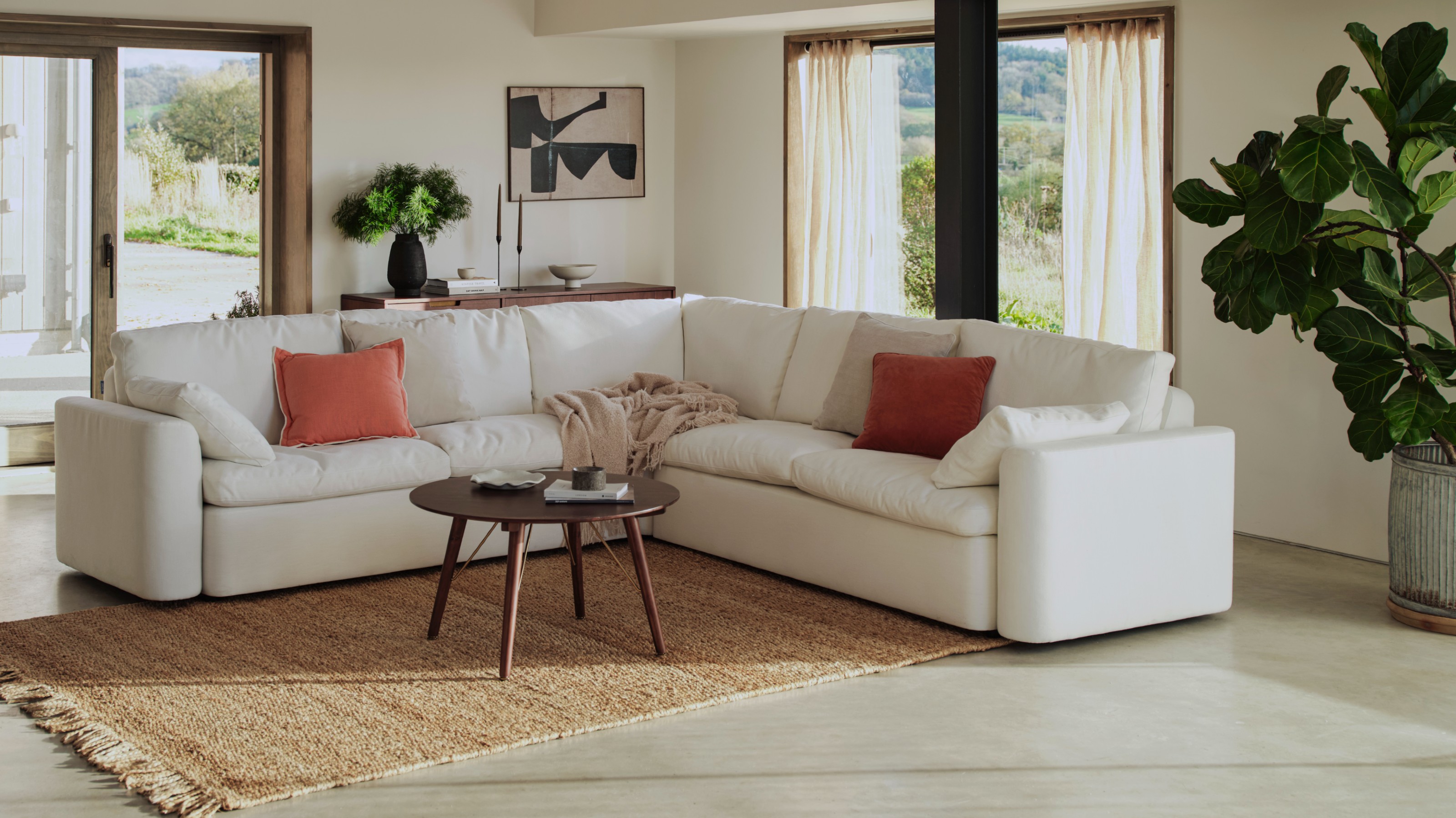 A large airy living room with Swyft&#039;s Model 13 modular corner sofa in white
