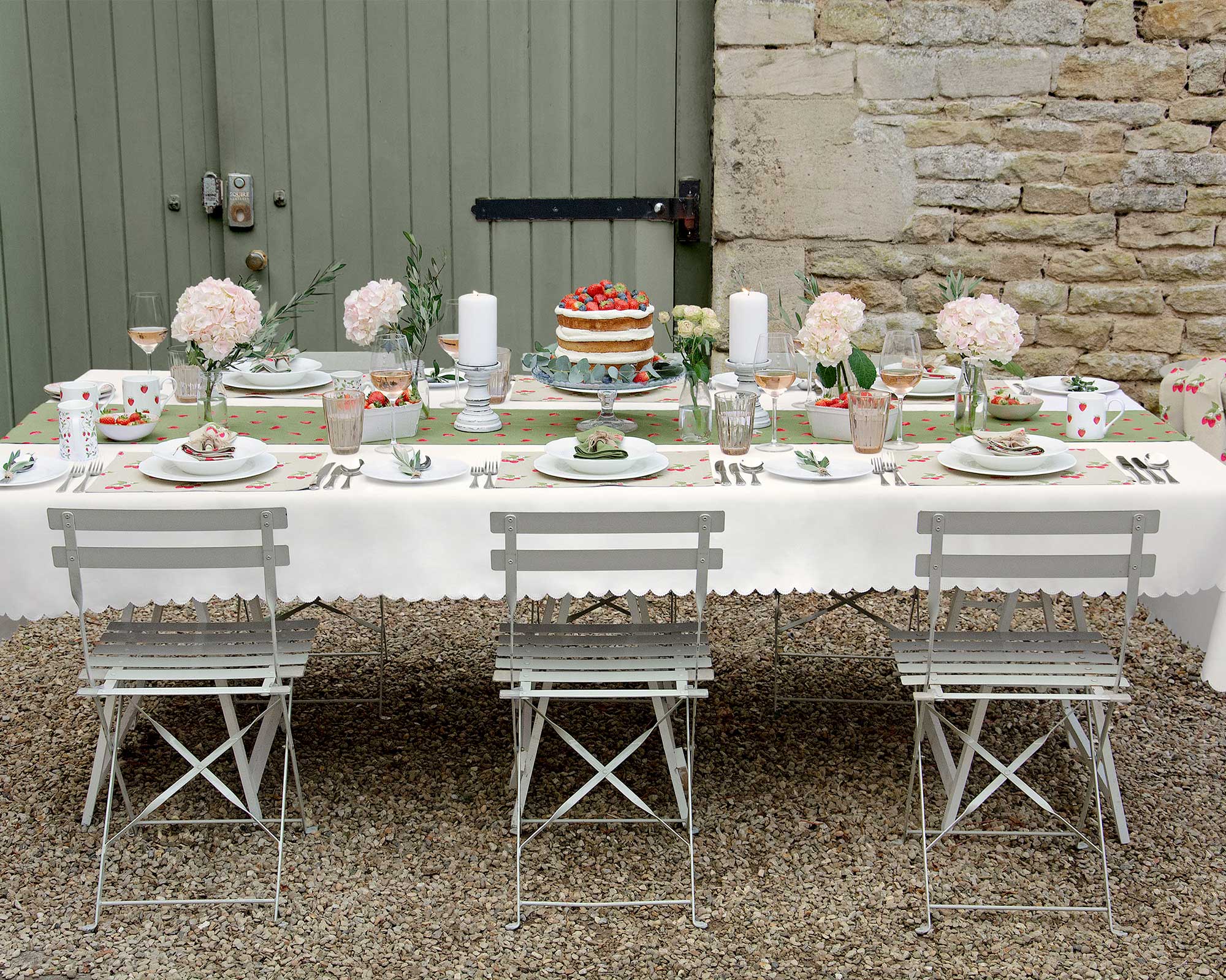 outdoor table on a gravel patio decorated for a garden tea party