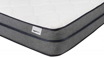 A closeup of the corner of the Amazon Basics Premium Foam Eurotop Mattress with a white Amazon Basics tag in the corner