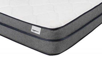 A closeup of the corner of the Amazon Basics Premium Foam Eurotop Mattress with a white Amazon Basics tag in the corner