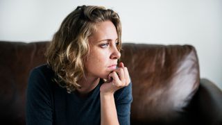 Woman with depression sitting on couch