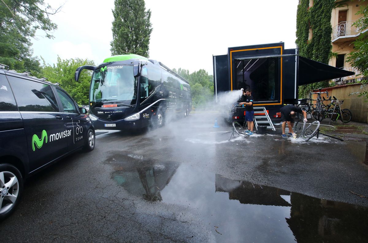 The Movistar mechanics wash down the team cars and bikes