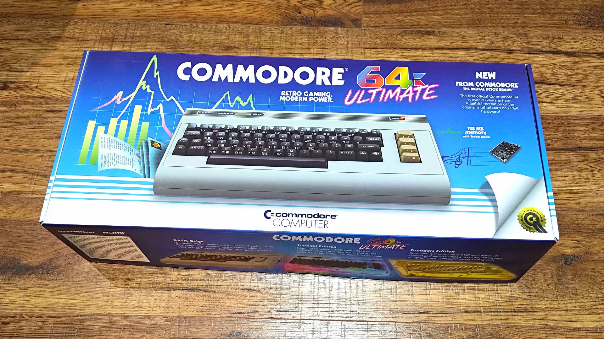 Commodore 64 Ultimate box lying on wood floor.