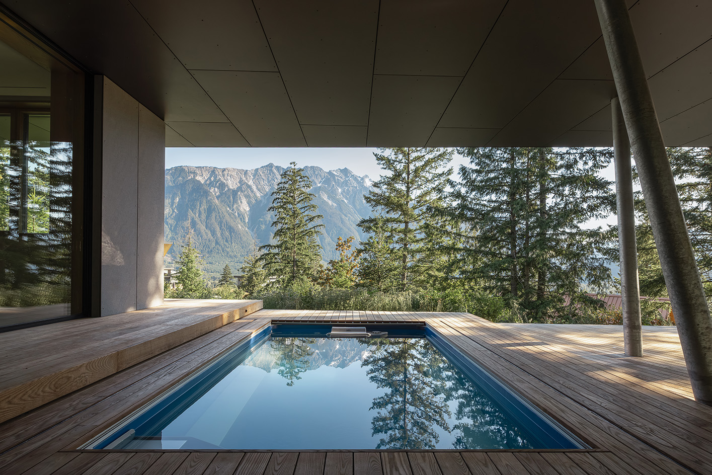 view of Passive House Forest Retreat, a timber structure engulfed in the tree canopy