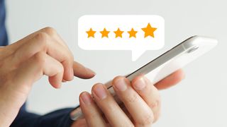 A person holds an iPhone, star ratings appear above it
