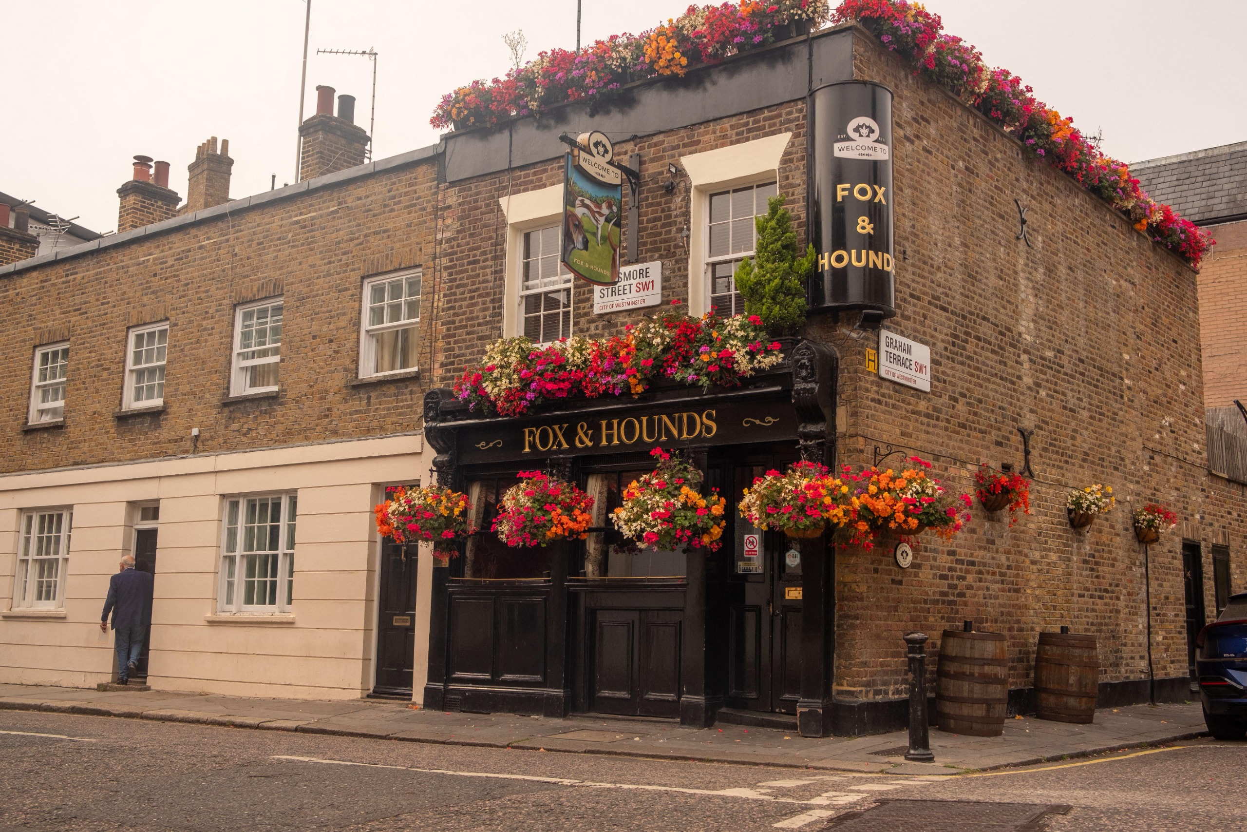 An extrenal view of the Fox &amp;amp; Hounds, covered in flowers