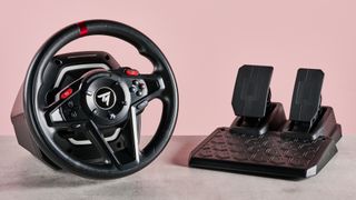 Thrustmaster T128 on desk with pink background