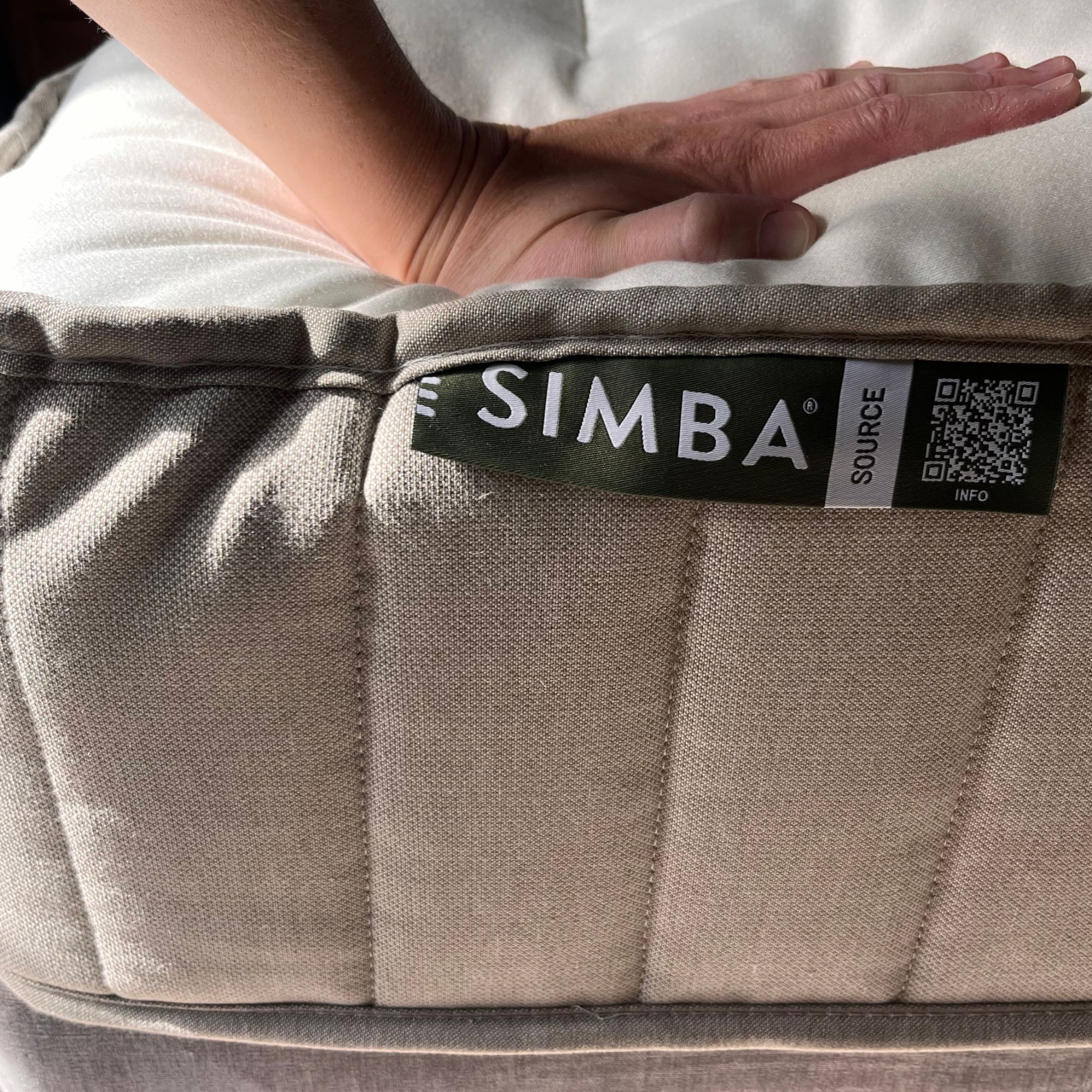 simba natural hybrid source with hand pressing down to test responsiveness