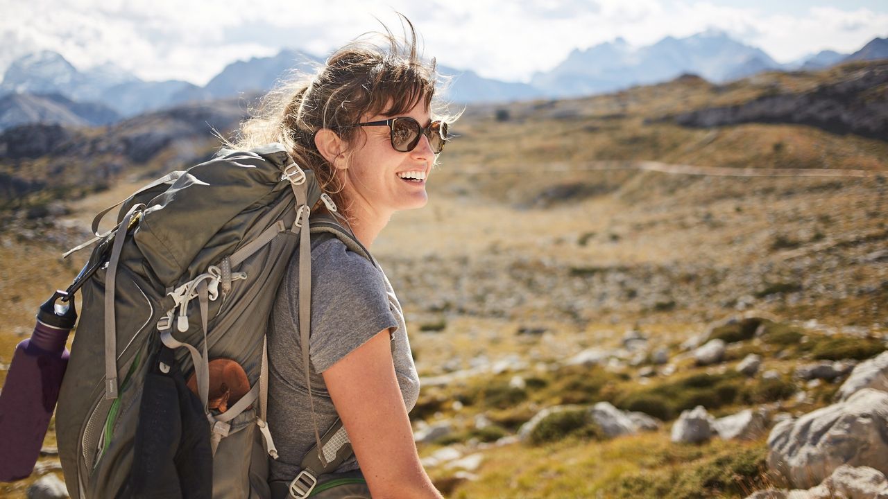 Does hiking build muscle? Image shows woman hiking in the mountains